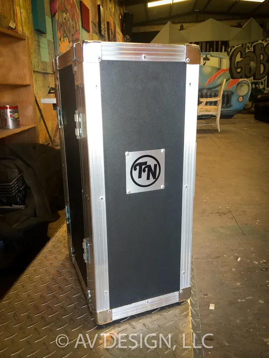 Black road case with aluminum trim and an inset logo plate