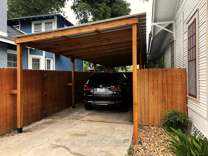 Carport with a cedar frame, metal roof and matching cedar privacy fence
