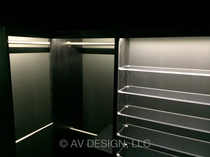 Dark-stained oak closet with LED-lit hanging rails and glass shelves