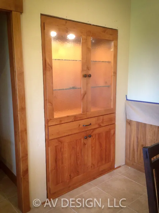 Stained corner display cabinet with glass shelves and recessed lighting