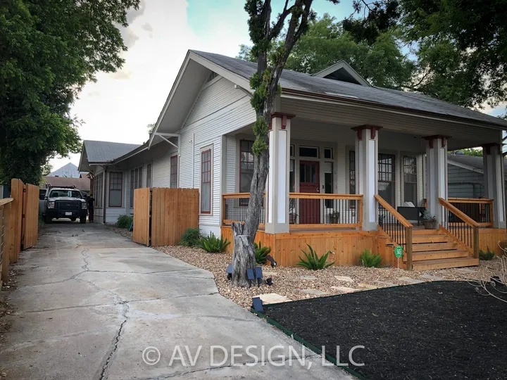 Craftsman house with a new porch and wood fence