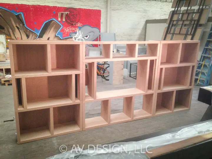 Custom oak shelving unit with asymmetrical open cubbies built in our San Antonio shop