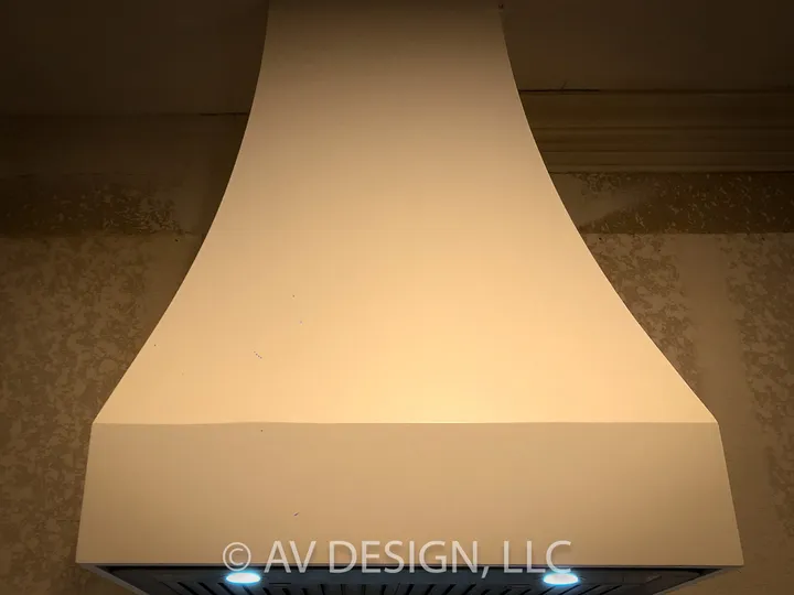 Custom curved range hood finished in plaster tone