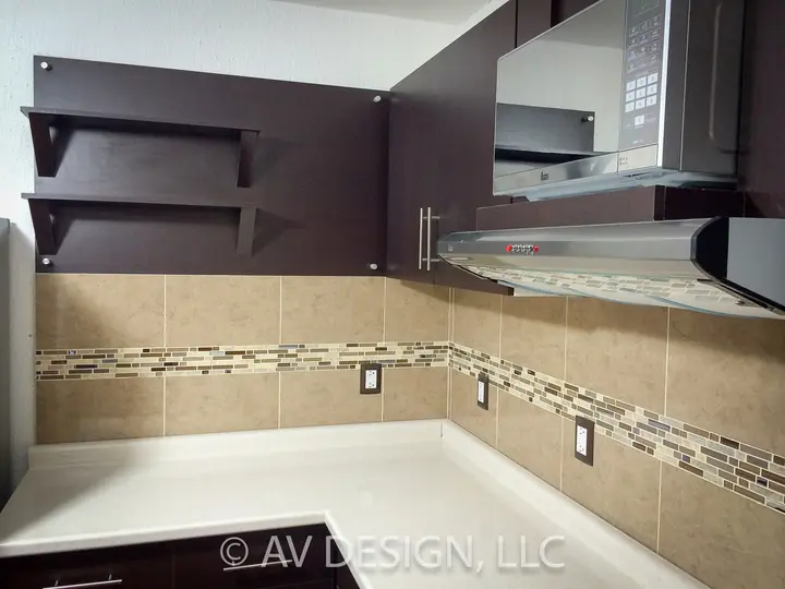 Kitchen with dark-stained cabinets, floating shelves and a tile backsplash with mosaic accent