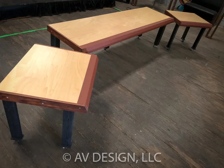 Maple-top benches with red-stained edges on steel legs