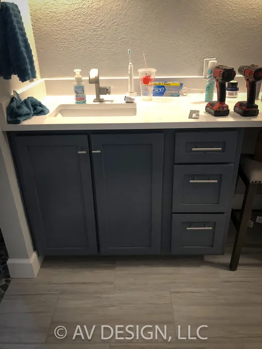 Navy blue vanity cabinet with drawers and brushed pulls