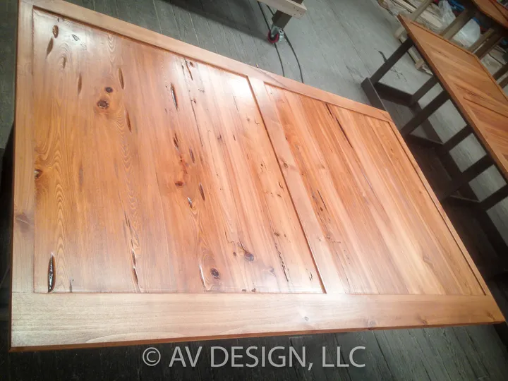 Reclaimed pine tabletop with a framed edge laid out on the shop floor