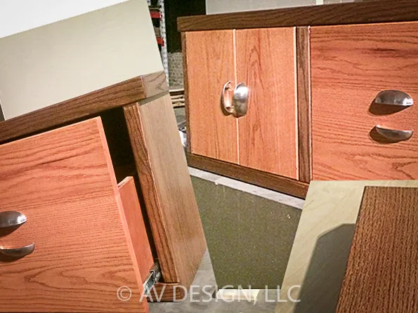 Red oak cabinet doors and drawers with cup pulls during assembly
