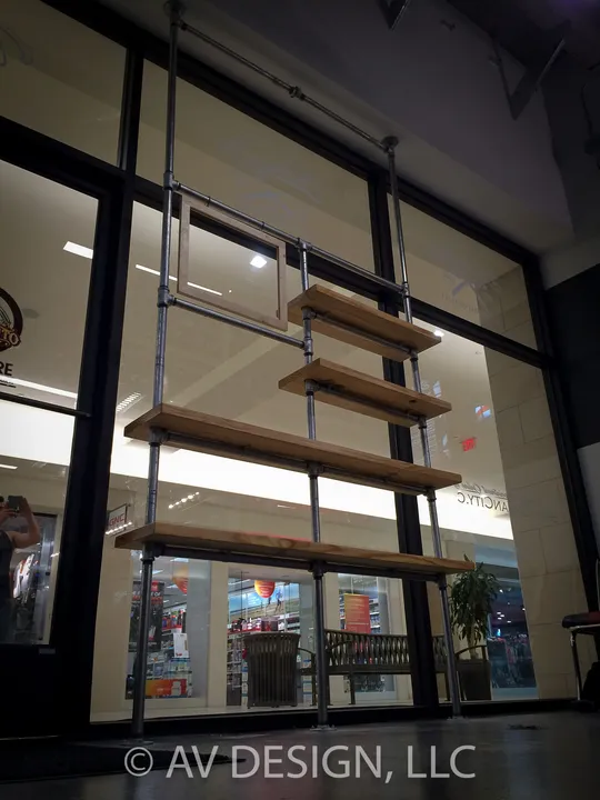 Wood shelves suspended on steel rods in a retail storefront window