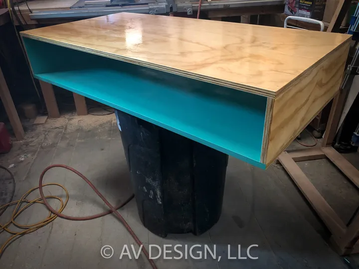 Plywood console table with a teal interior