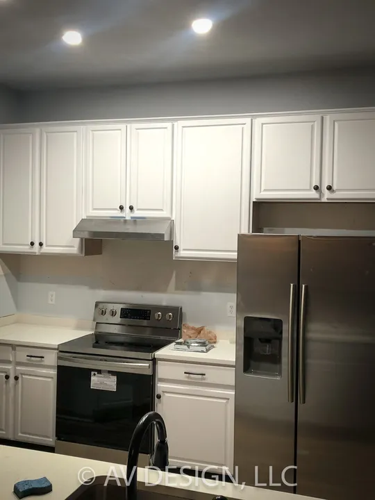 Kitchen with white shaker cabinets and stainless appliances